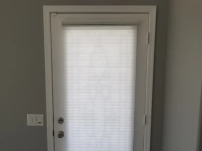 Cellular shade cover a door